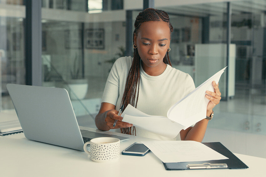 Female reading the December 2024 jobs report looking at November U.S. labor market and economy trends.