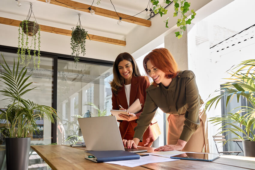 Female coworkers reviewing the January 2025 jobs report, on a laptop, looking at December 2024 labor market and economy trends. 