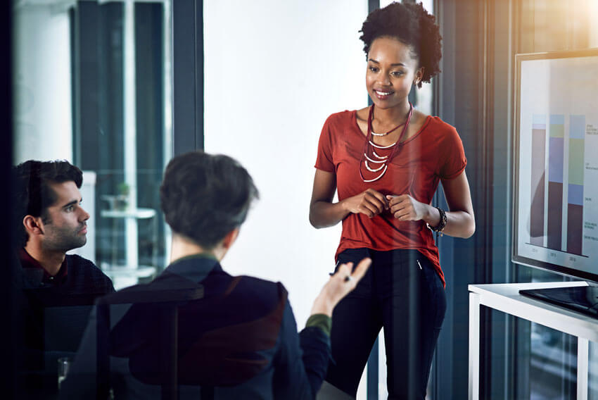 Female and men coworkers reviewing September's 2024 jobs report looking at labor market trends in August.